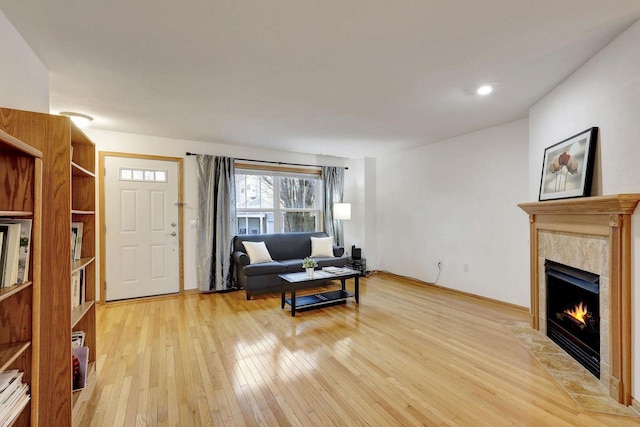 living area with light wood-type flooring and a fireplace