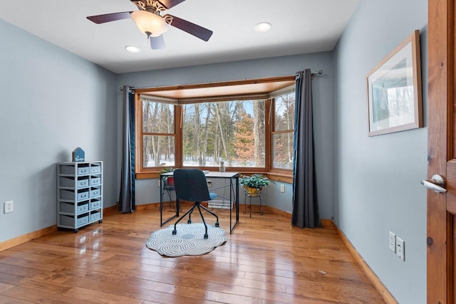 office area with hardwood / wood-style floors and ceiling fan