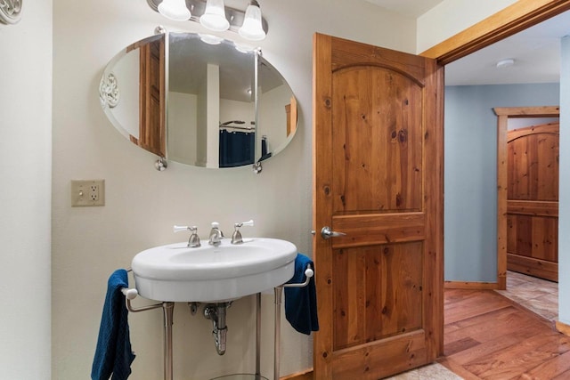 bathroom with wood-type flooring