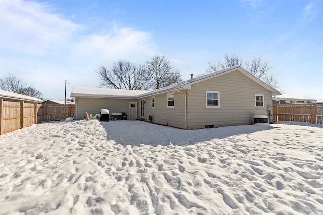 view of snow covered rear of property