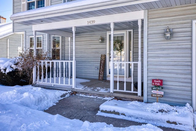 view of snow covered property entrance