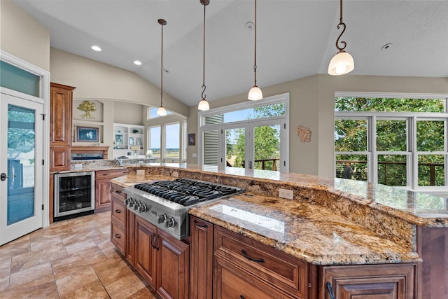 kitchen featuring french doors, stainless steel gas stovetop, hanging light fixtures, a kitchen island, and wine cooler