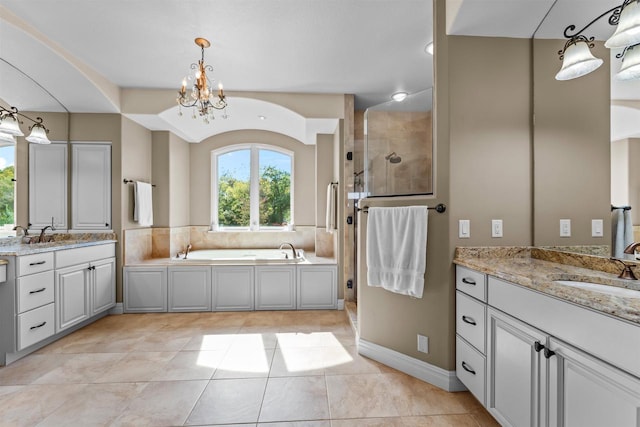 bathroom featuring separate shower and tub, vanity, tile patterned flooring, and an inviting chandelier