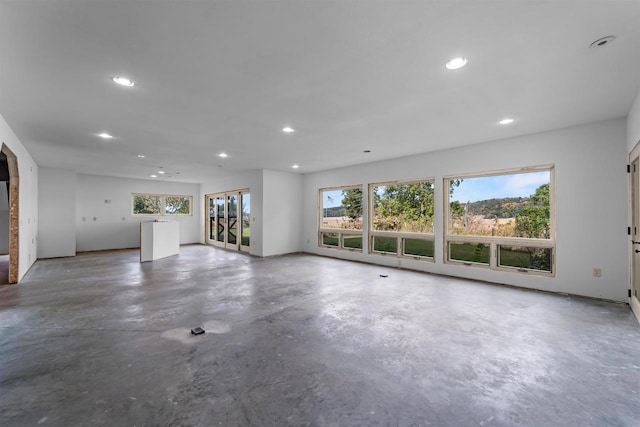 unfurnished living room featuring concrete floors