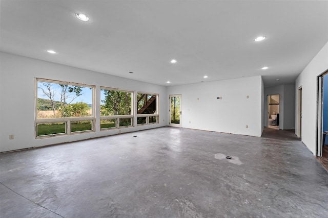 unfurnished living room featuring a wealth of natural light