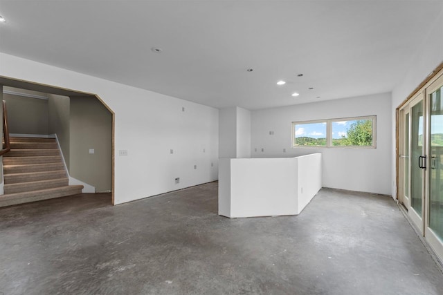 spare room featuring a healthy amount of sunlight and concrete floors