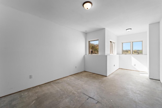 empty room with concrete flooring