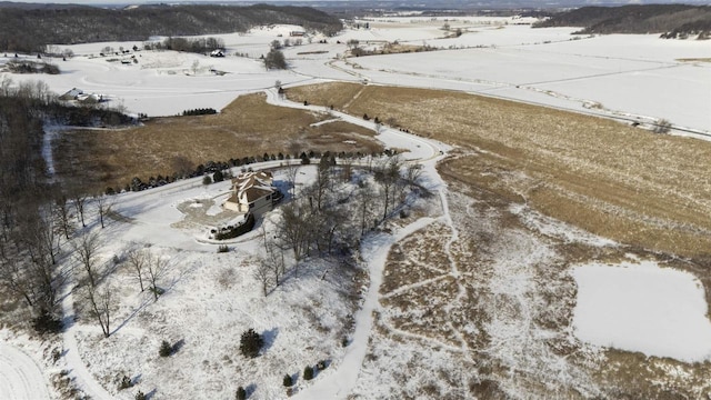 snowy aerial view featuring a rural view