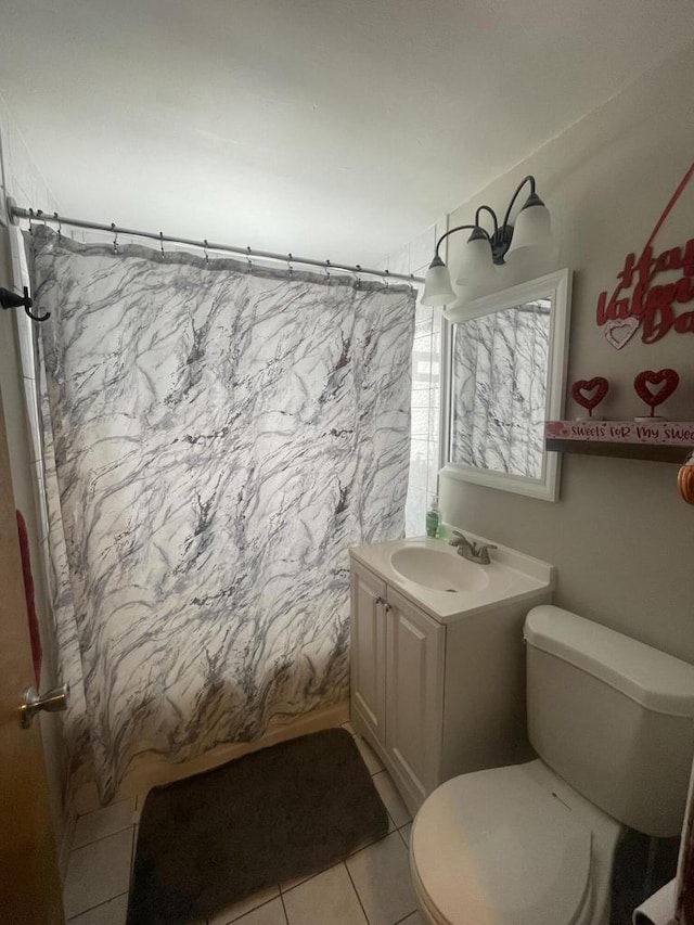 bathroom featuring a shower with shower curtain, vanity, toilet, and tile patterned floors