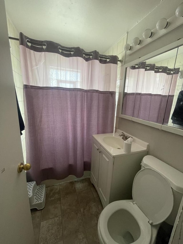 full bathroom with shower / bath combination with curtain, vanity, and toilet