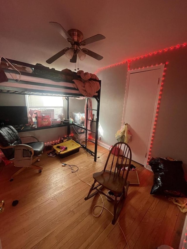 bedroom with ceiling fan and light hardwood / wood-style floors