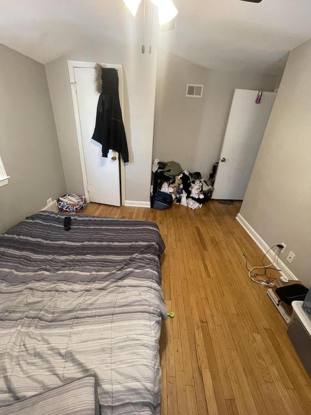 bedroom with wood-type flooring