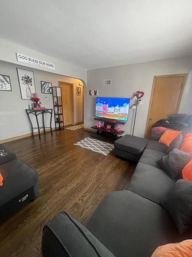 living room with dark hardwood / wood-style flooring