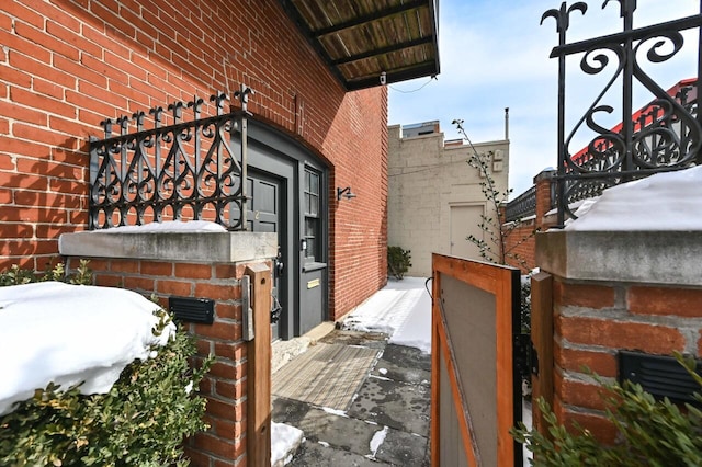 1442 N Franklin Pl Unit 2, Milwaukee, WI 53202 - view of snowy exterior featuring brick siding
