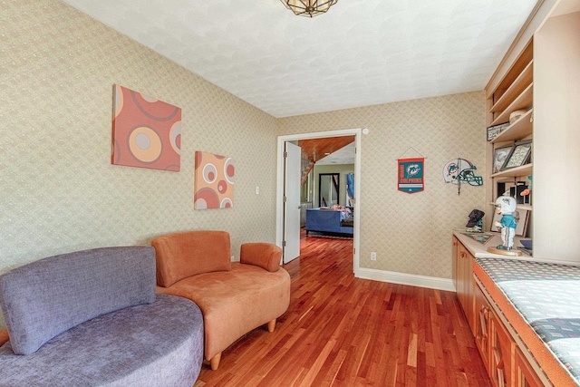 living area with hardwood / wood-style floors and a textured ceiling