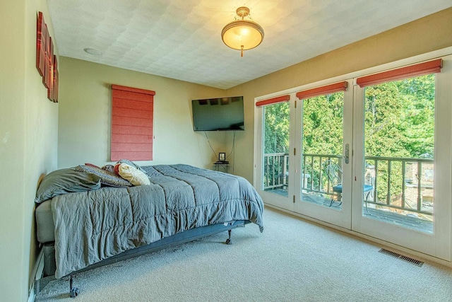 bedroom with carpet flooring and access to exterior