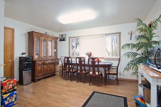 dining room with light hardwood / wood-style flooring