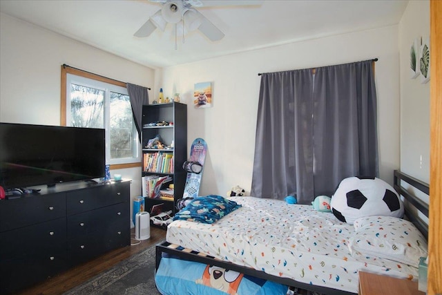 bedroom with ceiling fan and dark hardwood / wood-style floors