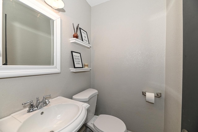 bathroom featuring sink and toilet