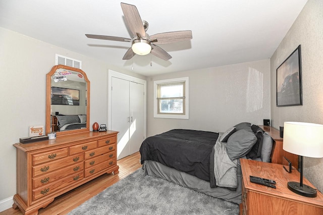 bedroom featuring a closet, ceiling fan, and light hardwood / wood-style flooring