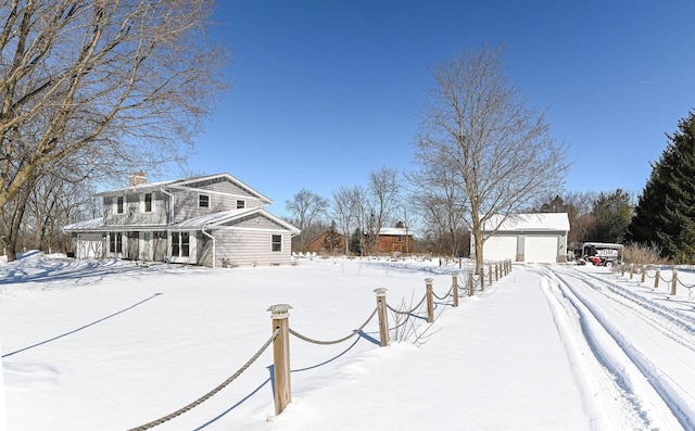 exterior space with a garage and an outbuilding