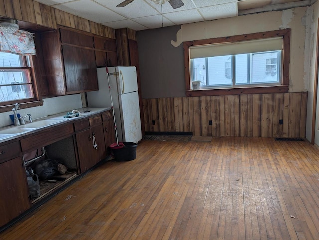 kitchen featuring a paneled ceiling, hardwood / wood-style floors, and a healthy amount of sunlight