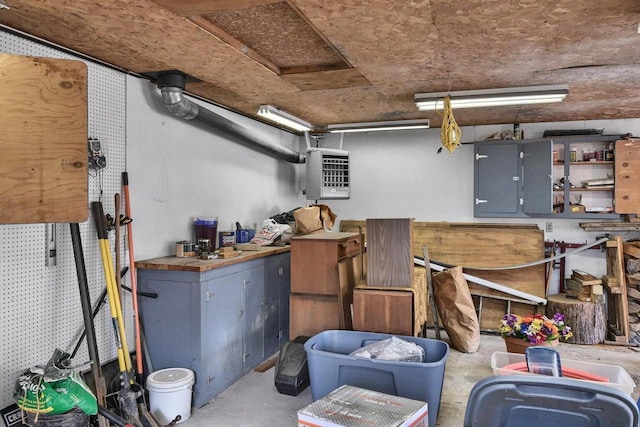 storage room featuring electric panel and heating unit