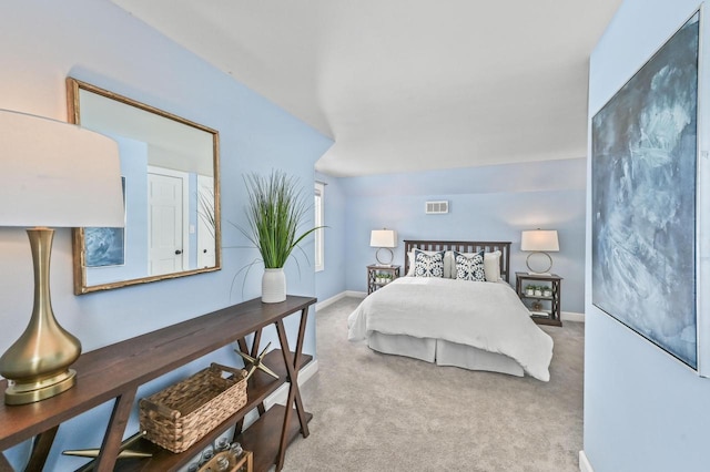 bedroom featuring vaulted ceiling and carpet