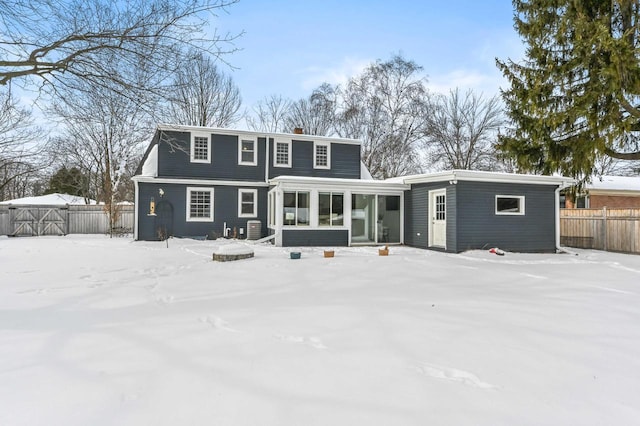 snow covered property featuring a sunroom