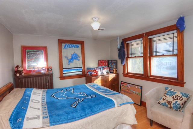 bedroom with hardwood / wood-style floors