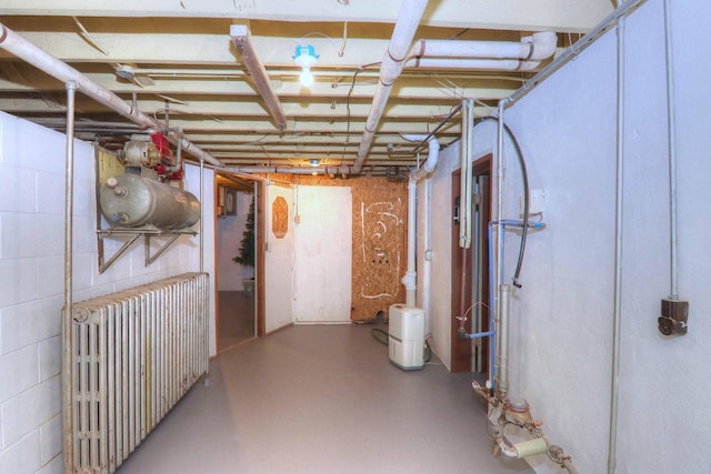 basement featuring radiator heating unit