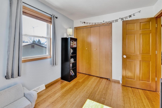 bedroom featuring a closet and light hardwood / wood-style flooring