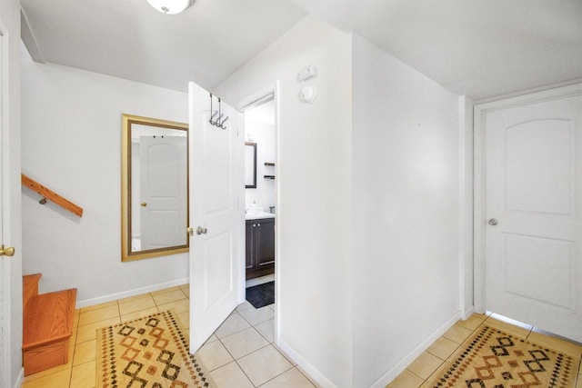 corridor featuring light tile patterned floors