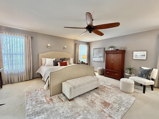 bedroom with light carpet and ceiling fan