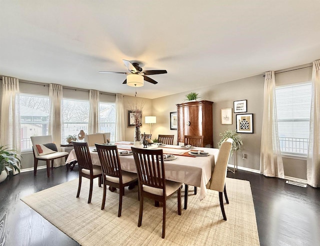 dining space featuring ceiling fan and dark hardwood / wood-style flooring