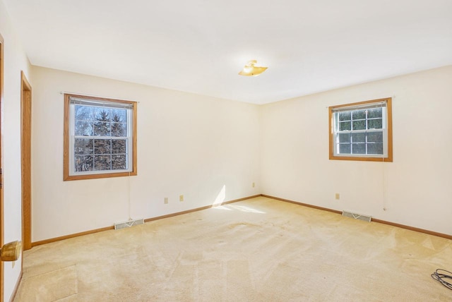 spare room with light colored carpet