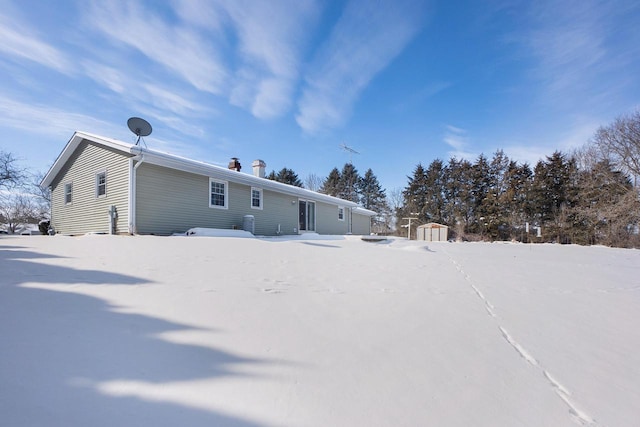 snow covered house with a shed