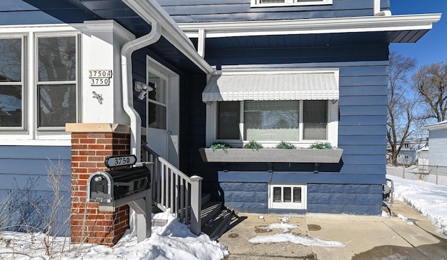 view of snow covered property entrance