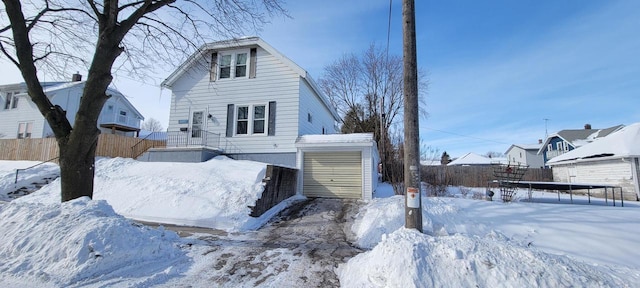 exterior space featuring a garage and an outbuilding