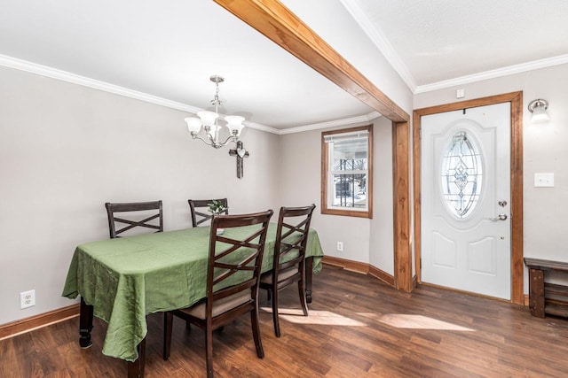 dining space featuring dark wood-type flooring, crown molding, and a chandelier