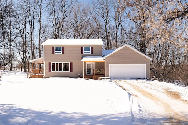 view of front property featuring covered porch and a garage