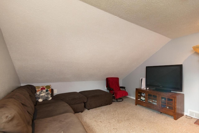 carpeted living room featuring a textured ceiling and vaulted ceiling