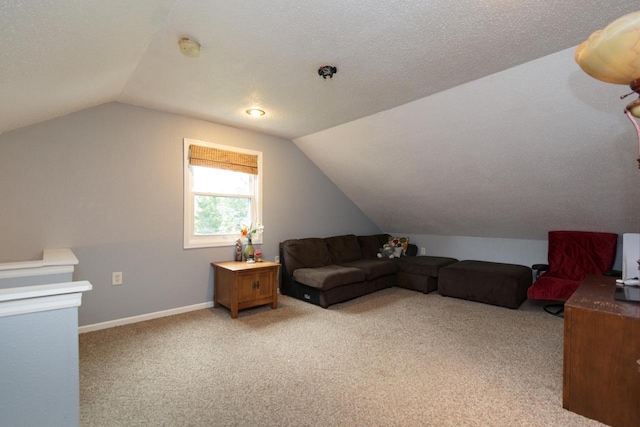 interior space featuring a textured ceiling, vaulted ceiling, and light colored carpet