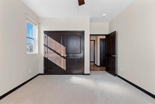 unfurnished bedroom with carpet flooring and ceiling fan