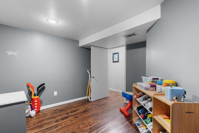 game room with dark hardwood / wood-style floors