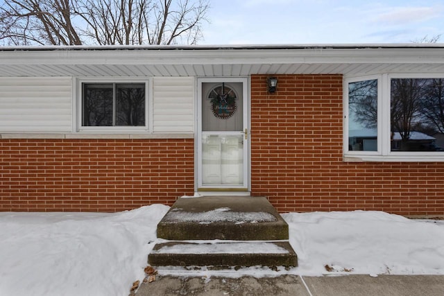 view of snow covered property entrance