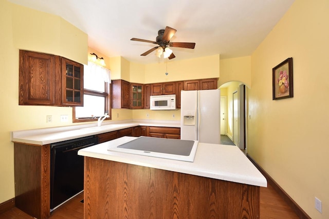 kitchen featuring ceiling fan, sink, black appliances, and a center island