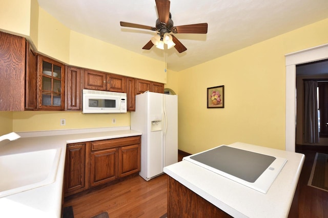 kitchen with white appliances, ceiling fan, light hardwood / wood-style flooring, and sink