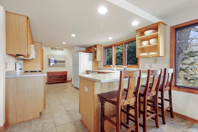 W5553 Oak Park Rd, Elkhorn, WI 53121 - kitchen featuring white appliances, sink, light brown cabinetry, kitchen peninsula, and a breakfast bar area