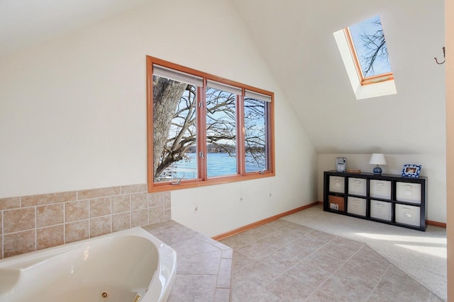 W5553 Oak Park Rd, Elkhorn, WI 53121 - bathroom with a bathtub and vaulted ceiling with skylight